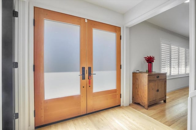 doorway to outside featuring french doors and light hardwood / wood-style flooring