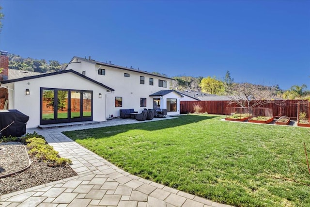 back of house featuring an outdoor living space, a lawn, and a patio