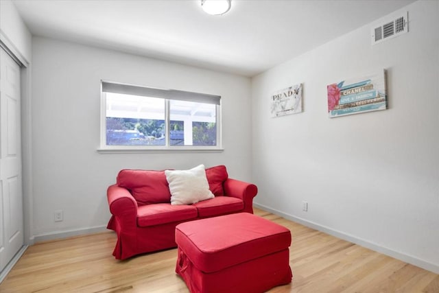 living area with hardwood / wood-style floors