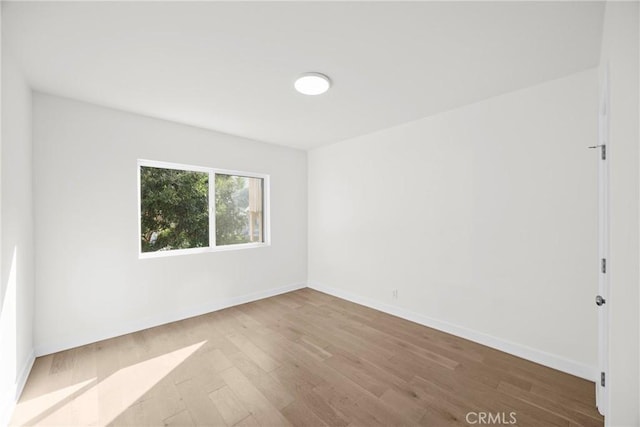 empty room with hardwood / wood-style floors