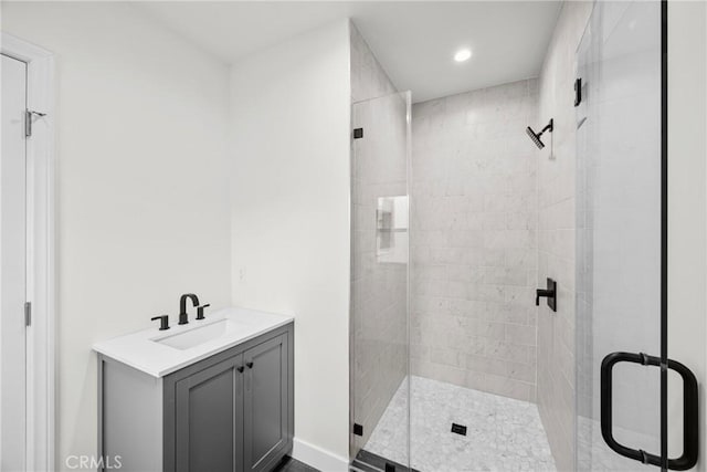 bathroom featuring vanity and an enclosed shower