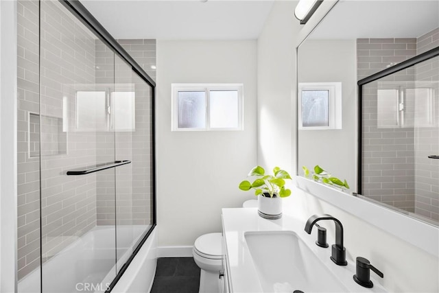 full bathroom with vanity, tile patterned floors, shower / bath combination with glass door, and toilet