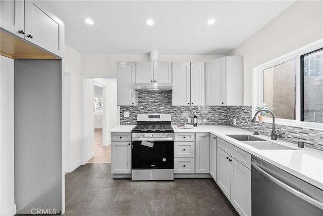 kitchen featuring stainless steel appliances, sink, and decorative backsplash