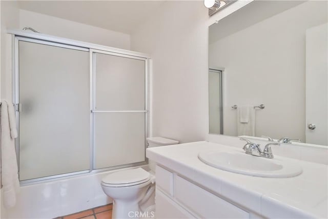 full bathroom featuring vanity, tile patterned flooring, toilet, and combined bath / shower with glass door