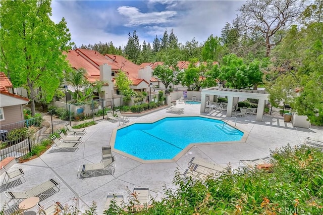 view of swimming pool with a pergola and a patio