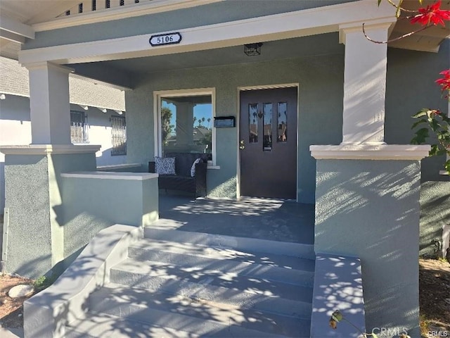 doorway to property featuring covered porch