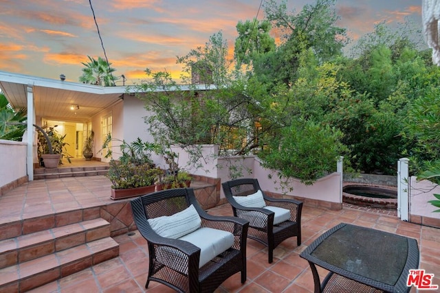 view of patio terrace at dusk