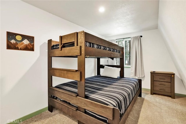 carpeted bedroom featuring baseboards