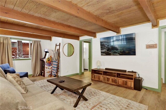 living room with beam ceiling, light hardwood / wood-style flooring, and wooden ceiling