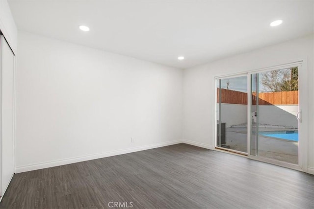 empty room with dark hardwood / wood-style floors