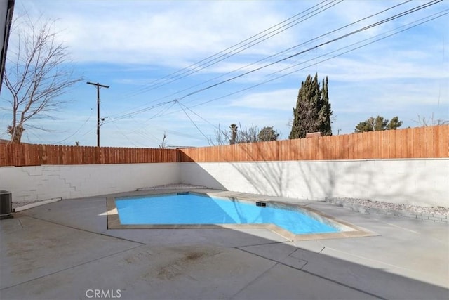 view of pool featuring a patio and central air condition unit