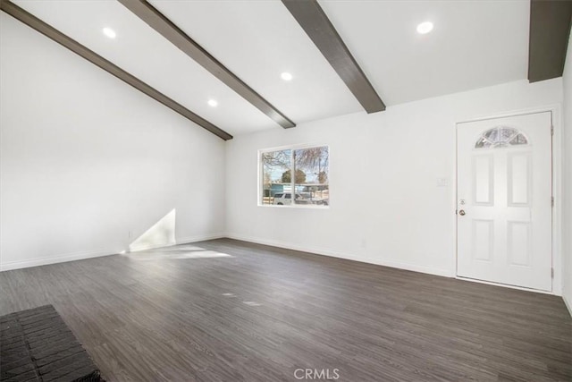 empty room with lofted ceiling with beams and dark hardwood / wood-style floors