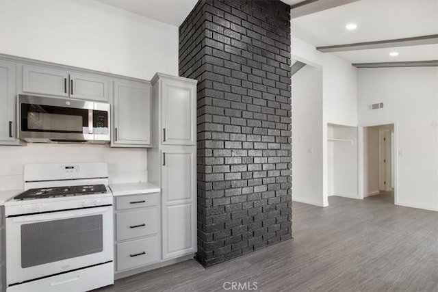 kitchen featuring white range with gas cooktop, gray cabinets, and light wood-type flooring