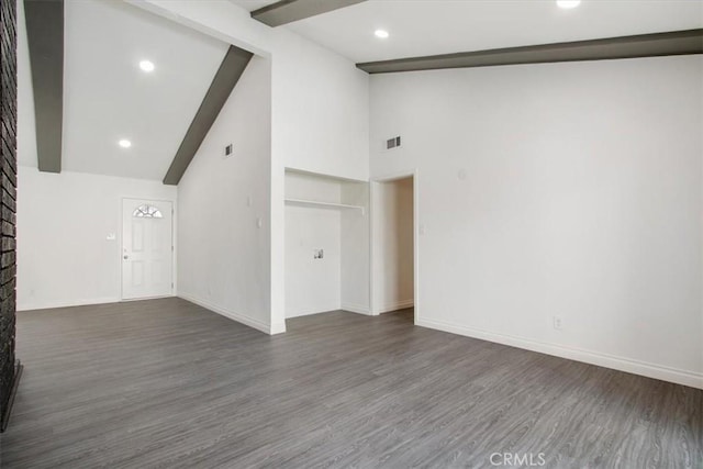 unfurnished room featuring beam ceiling, high vaulted ceiling, and dark hardwood / wood-style flooring