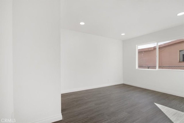 empty room with dark wood-type flooring