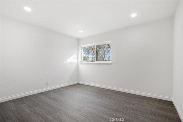 empty room with dark wood-type flooring