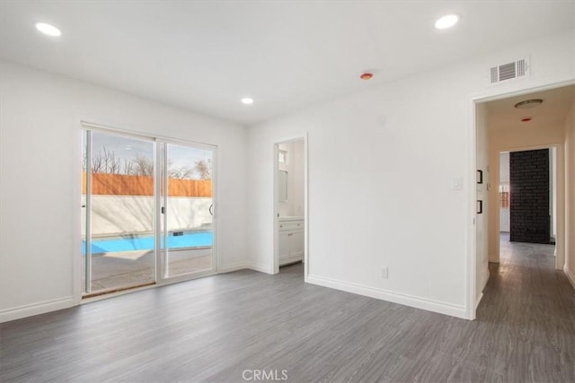 unfurnished room with dark wood-type flooring