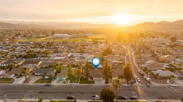 aerial view at dusk featuring a mountain view