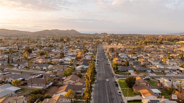 aerial view at dusk featuring a mountain view