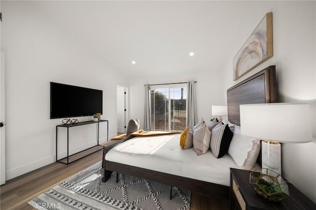 bedroom with hardwood / wood-style flooring and vaulted ceiling