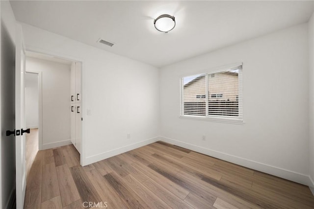 unfurnished room with hardwood / wood-style flooring