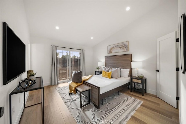 bedroom with lofted ceiling and light hardwood / wood-style flooring