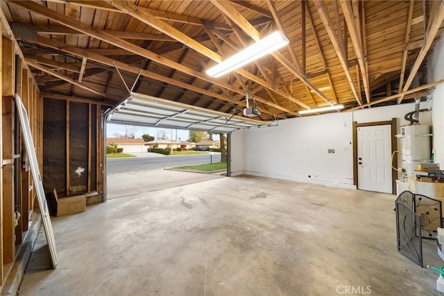 garage with secured water heater and a garage door opener