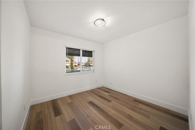 unfurnished room featuring hardwood / wood-style flooring