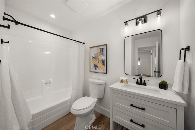 full bathroom with shower / bathtub combination with curtain, vanity, hardwood / wood-style flooring, and toilet