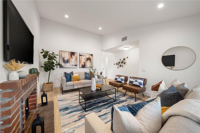 living room with a fireplace and hardwood / wood-style floors