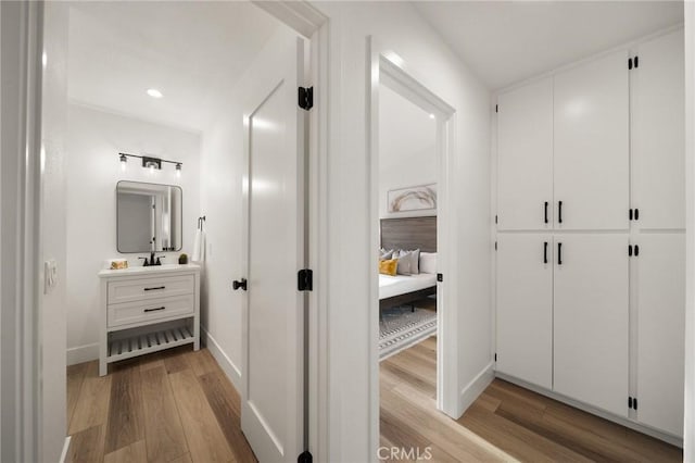 hall featuring sink and light hardwood / wood-style floors