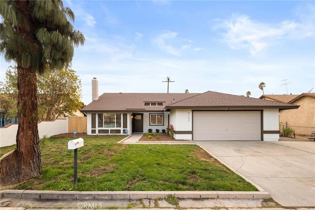 single story home with a garage and a front lawn