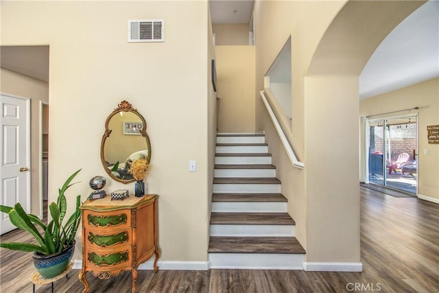 stairway with hardwood / wood-style floors