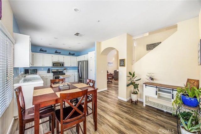 dining space featuring hardwood / wood-style flooring