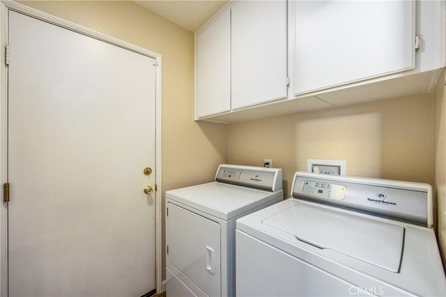 washroom featuring cabinets and separate washer and dryer