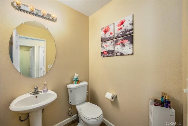 bathroom featuring sink and toilet