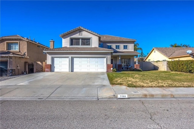 view of property with a garage and a front lawn