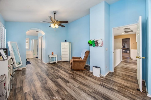 living area with dark wood-type flooring and ceiling fan