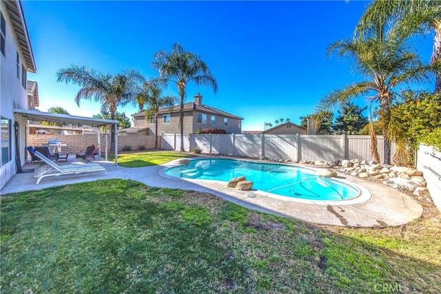 view of swimming pool with a yard and a patio area