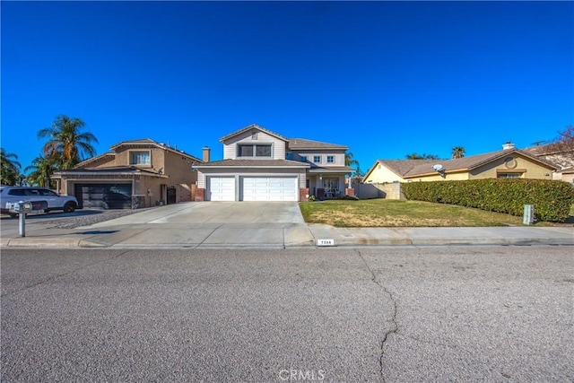 view of front of property featuring a garage and a front lawn