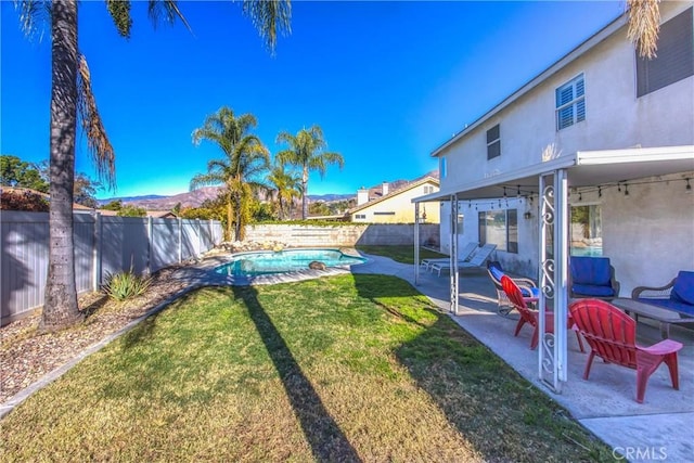 view of yard featuring a fenced in pool and a patio