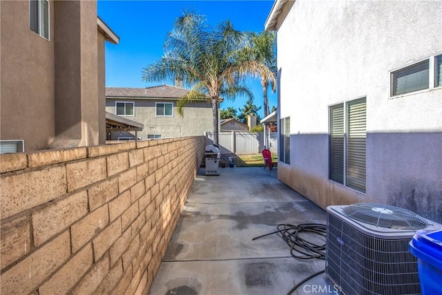 view of property exterior with a patio and central air condition unit