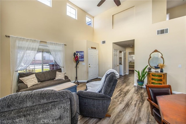 living room featuring dark hardwood / wood-style flooring and ceiling fan