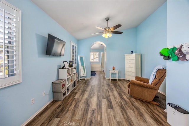 living area with lofted ceiling, dark hardwood / wood-style floors, and ceiling fan