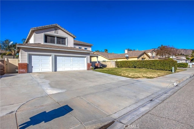 view of front property featuring a garage and a front yard