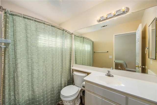 bathroom with vanity, toilet, and a shower with shower curtain