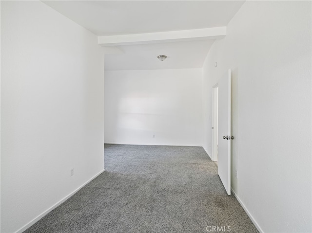 empty room with beamed ceiling and carpet floors