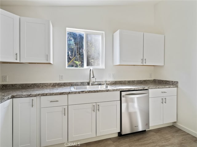 kitchen with white cabinetry, dishwasher, and sink