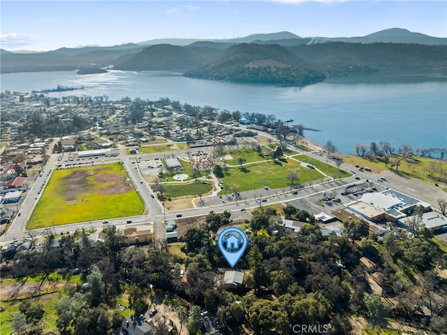 drone / aerial view featuring a water and mountain view