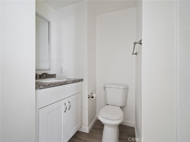 bathroom featuring hardwood / wood-style flooring, vanity, and toilet